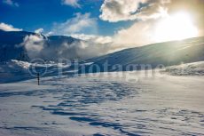 The Emparis plateau on snowshoes in the evening in winter